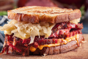 A close-up image of a Reuben sandwich with corned beef and sauerkraut at a local restaurant in Springfield, IL.