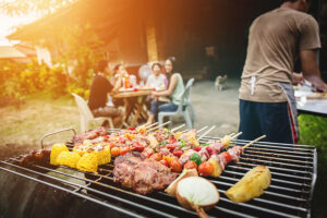 Family and friends at a residential home in Springfield, IL grilling kabobs and other BBQ foods recommended by a local restaurant.