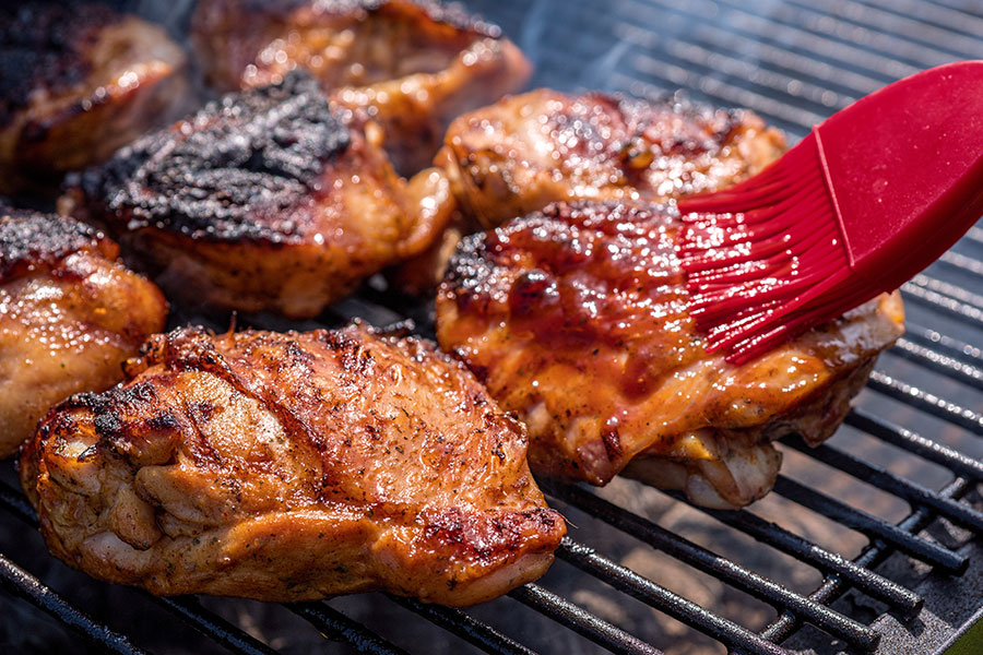 A close-up image of BBQ chicken on the grill at a residential summer BBQ in Springfield, IL.