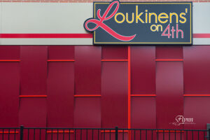 A view of vivid red wall outside of the restaurant Loukinens’ on 4th in Springfield, IL, the perfect place to have your next date night..