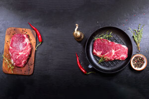 A steak is being cooked in a pan in Springfield, IL home.